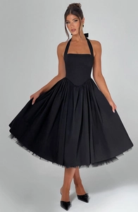 Detail of black halter dress with tiered puffy skirt and elegant mesh lining hemline