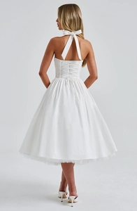 Detail of elegant white halter neck dress featuring a back lace-up closure and bow tie