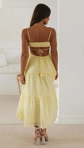Detail view of backless strapless lemon yellow maxi dress with multi-layered tiered skirt