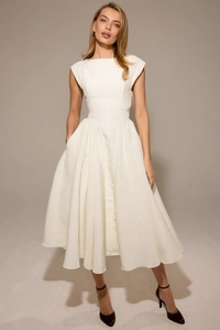Detail of the ivory white A-line dress with sleeveless cut and elegant pleated skirt