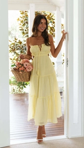 Detail of yellow backless maxi dress with cut-out waist and tiered ruffle skirt