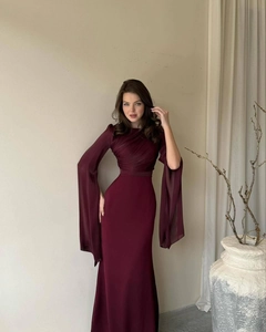 Detail of burgundy evening dress with elegant batwing sleeves and pleated bodice