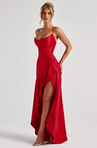 Detail of red satin dress featuring halter neck, draped chest, and ruffled slit hemline