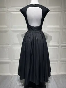 Detail view of black backless midi dress with elegant U-shaped open back and button closure