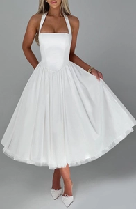 White halter neck dress with voluminous layered tulle skirt and open back detail