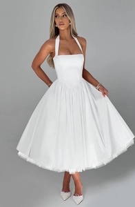 Close-up of white halter neck evening dress with satin bodice and voluminous tulle skirt
