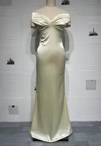 Detail of champagne gold velvet mermaid dress featuring pleated off-shoulder neckline