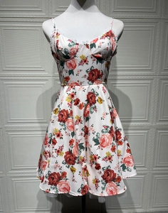 Close-up of floral satin dress featuring delicate white lace trim and bustier pleats