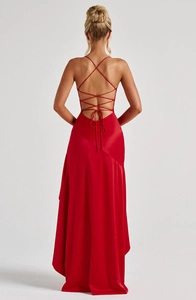 Detail of red satin backless evening dress featuring elegant criss-cross lace-up straps