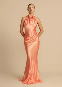 Detail of coral satin maxi dress showing halter neckline with elegant draped fold texture