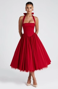 Detail of red halter dress featuring a tied bow neck and puffy tulle-lined hemline