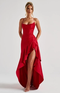 Close-up of elegant red satin evening dress with ruffles and high-slit detail