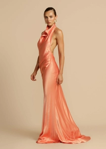 Macro shot of the silky satin fabric and backless detail of this peach evening dress