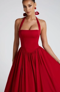 Detail of red halter neck evening gown with ruffled puffy skirt and slim waist design