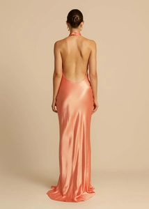 Macro detail of elegant apricot satin backless halter dress showing luxurious fabric texture