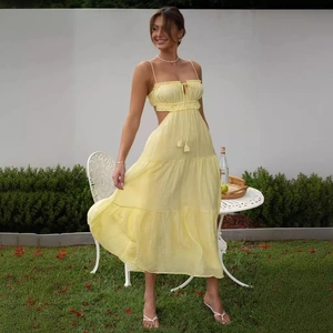 Sleeveless pale yellow maxi dress with waist cut-outs and tiered skirt for summer