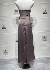 Detail of satin long dress back with hidden zipper and ruched fabric texture