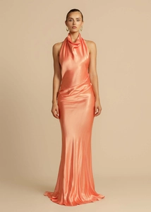 Detail of elegant peach satin halter neck dress with sophisticated draped pleats