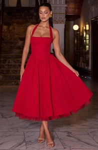 Detailed close-up of red halter midi dress with full pleated skirt and mesh lining support