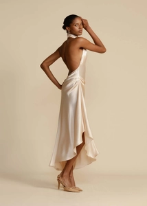 Detailed view of champagne satin dress with side ruching and elegant asymmetrical hemline