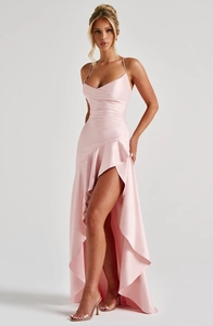 Detail of light pink satin dress with halter neck and irregular ruffled hemline