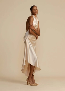 Detail of champagne satin dress showing halter neck, cowl neckline and side ruched texture