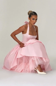 Detail of light pink satin evening gown featuring an open back with a delicate bow tie knot