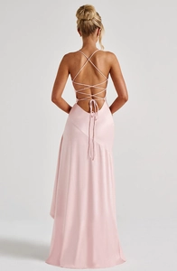 Detail of the backless satin dress showing delicate criss-cross straps and silky fabric