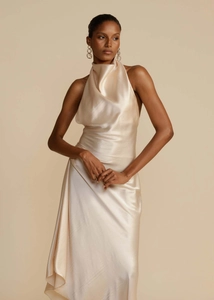 Detail of elegant satin halter neck dress with draped neckline and smooth finish