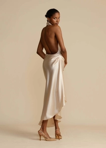 Detail of elegant backless satin dress showing the graceful drape and high-gloss finish