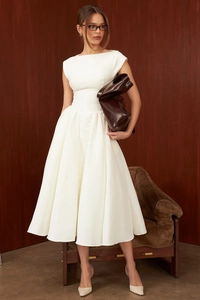 Detailed full-length view of a white sleeveless backless dress with a wide flared hem