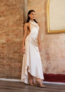 Detail of elegant champagne satin evening dress with side ruching and split hem