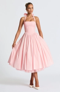 Detail of light pink halter dress featuring a large bow and layered tulle underskirt