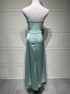 Detail view of mint green satin evening dress featuring an invisible back zipper and ruching