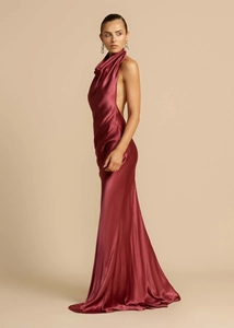 Close-up of elegant wine red satin dress with backless design and cowl neck detail
