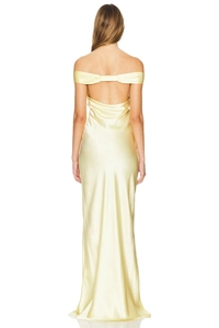 Detail showing the elegant backless design and silky satin texture of the yellow evening gown