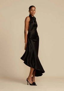 Detail view of smooth black satin fabric and side ruffle on backless split dress