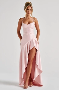 Detail of light pink satin evening dress featuring delicate ruffles and high-slit hemline