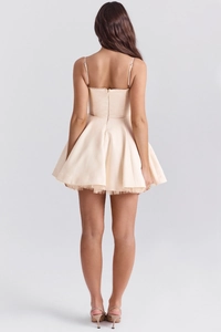 Back view of a champagne satin mini dress with puffy tulle lining and thin straps