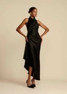 Detail of elegant black satin halter neck dress with high-low hem and ruffled textures
