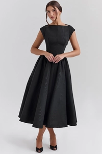 Macro view of a black sleeveless boat neck dress with elegant gathered waist and large skirt