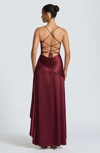 Detail of cross lace-up open back design on a burgundy satin evening gown
