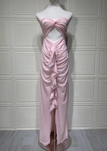 Detail of pink strapless dress with ruching, front cutout, and elegant vertical ruffles