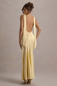 Detail of champagne satin backless fisheye dress with long vertical flowing ribbons