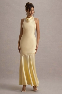 Detail of elegant pale yellow satin fishtail gown with halter neckline and silky texture