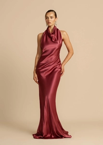 Close-up of elegant cowl neck and glossy satin fabric texture on a burgundy evening dress