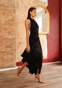 Detail of elegant black satin halter dress with draped cowl neck and backless design