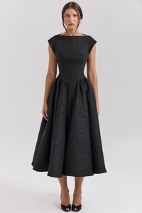 Detail view of the black midi dress featuring a textured moire fabric and pleated A-line skirt