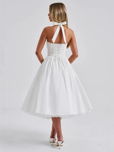 Elegant white halter midi dress with back lace-up detail and a large decorative bow