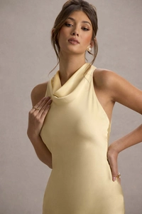 Detail of elegant cowl neck design on a pale yellow satin evening gown with silky texture